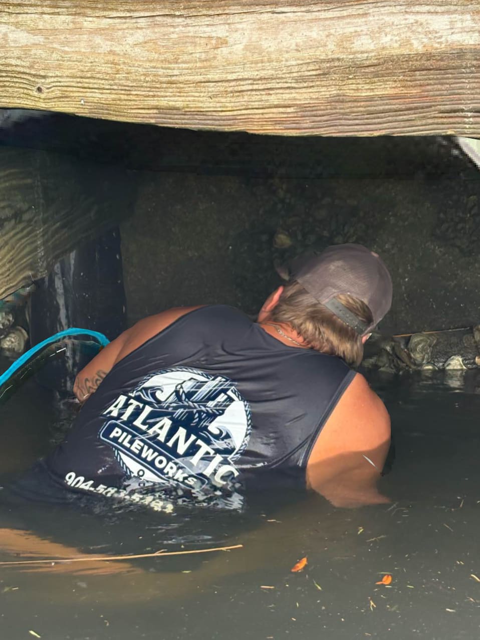 Atlantic Pileworks crew member inspecting a dock piling underwater