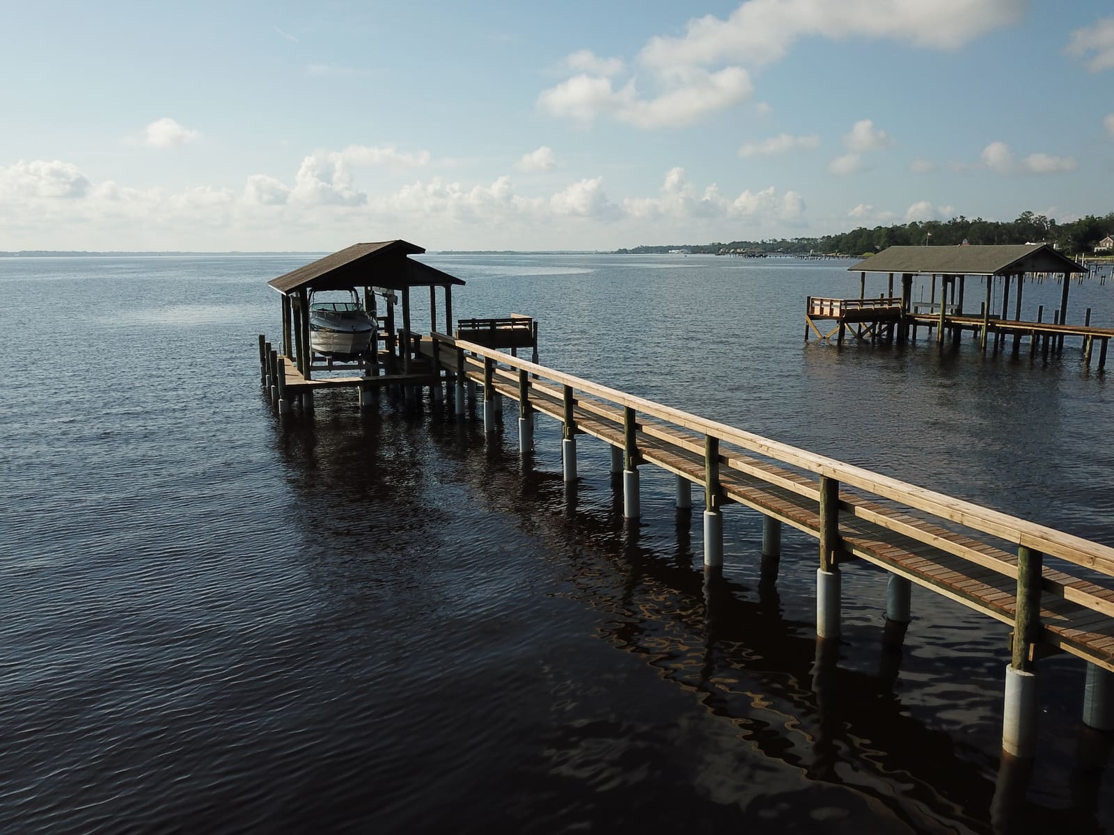 Long walkway and covered boathouse on the St. Johns River